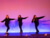 three girls move in front of a shadow wall