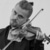 Picture of Dmitry Smirnov, violinist. He is holding his violin in his hand and playing it, his head is tilted.