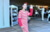 young woman with walking cane in red and white striped costume